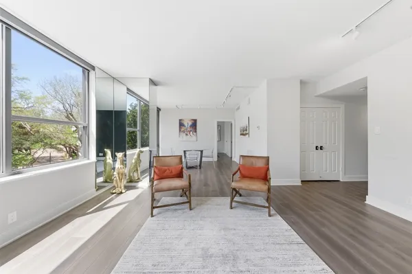 a living room with furniture and a floor to ceiling window