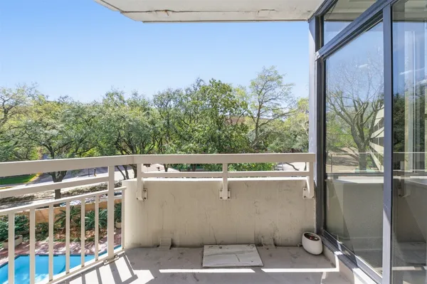 a view of a balcony with chairs