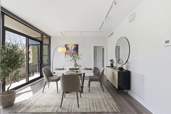 a work room with furniture and large windows