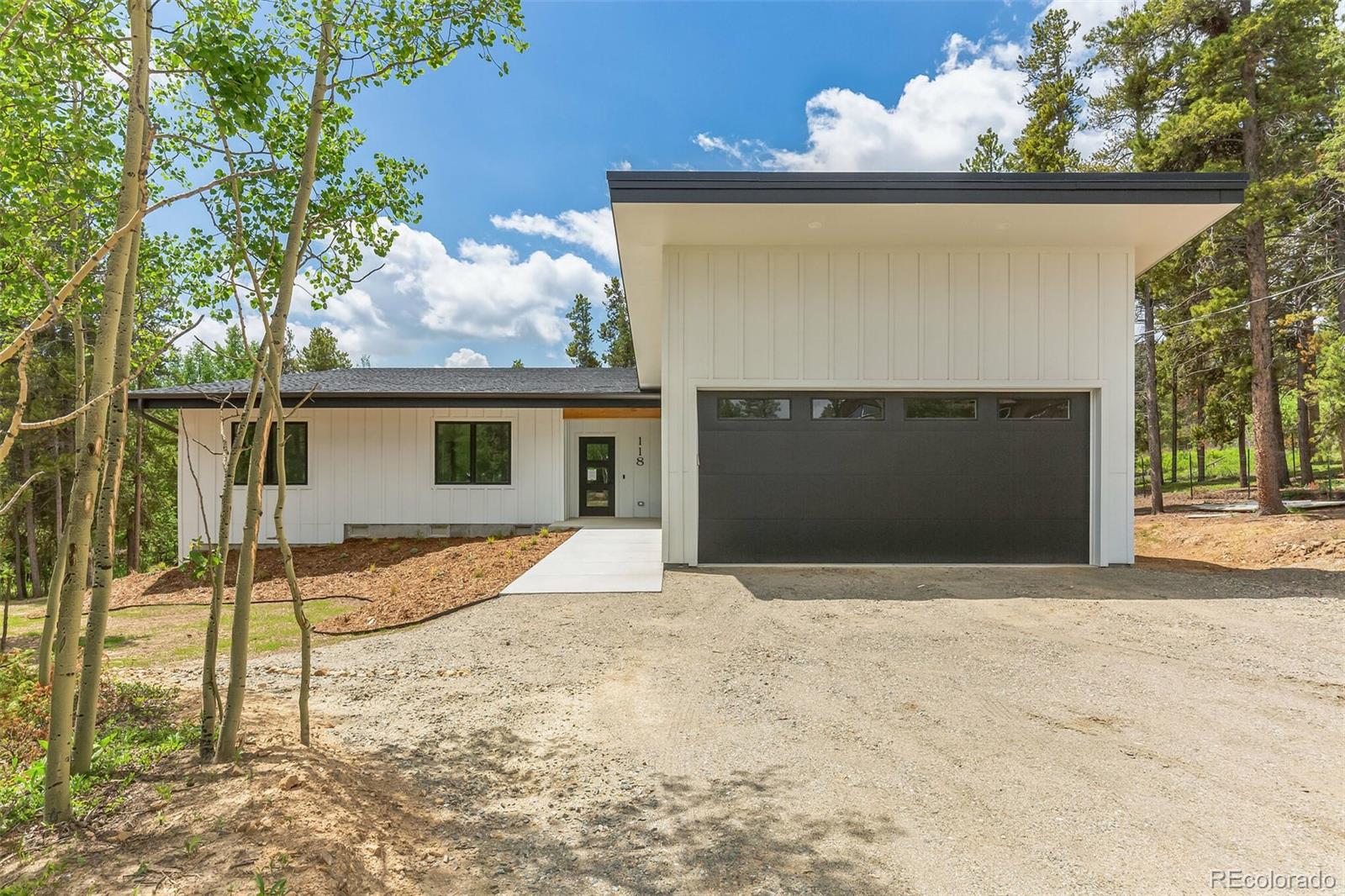 118 Quartz Road Black Hawk, CO 80422 - Photo 1 of 35 a front view of a house with a yard and garage