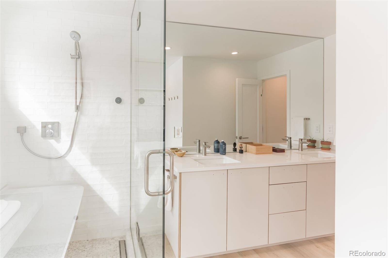 118 Quartz Road Black Hawk, CO 80422 - Photo 16 of 35 a bathroom with a double vanity sink a mirror and shower