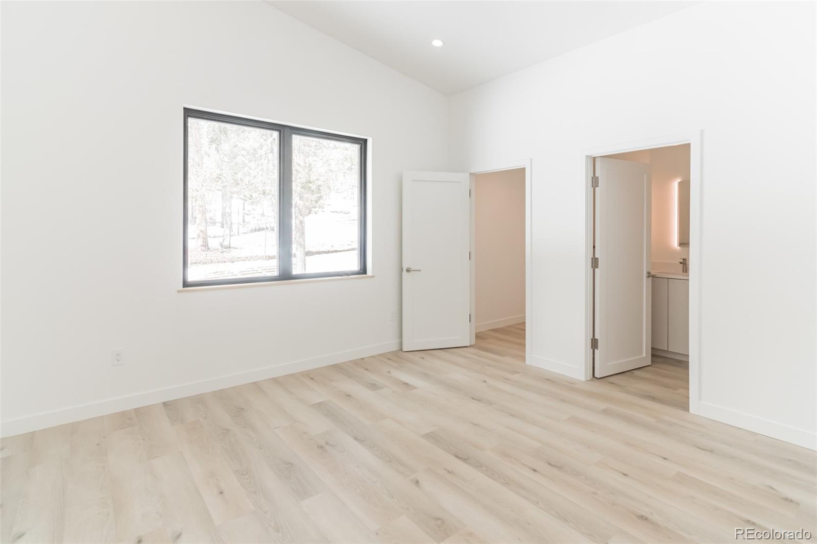 118 Quartz Road Black Hawk, CO 80422 - Photo 23 of 35 an empty room with wooden floor and windows