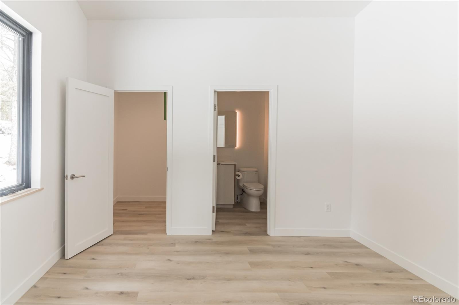 118 Quartz Road Black Hawk, CO 80422 - Photo 24 of 35 a view of an empty room with wooden floor and a window