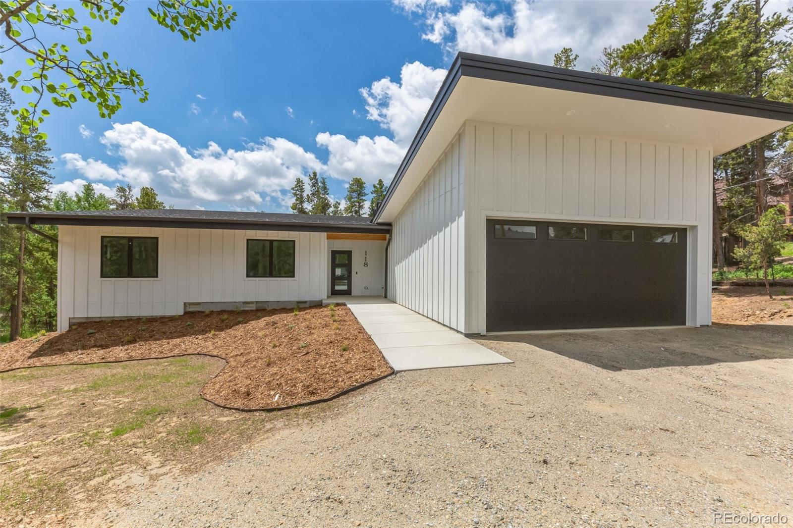 118 Quartz Road Black Hawk, CO 80422 - Photo 34 of 35 a front view of a house with a yard and garage