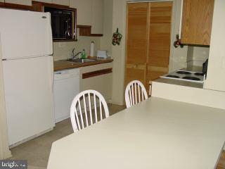 0 Edward Taylor Road, Unit 30 Ocean City, MD 21842 - Photo 2 of 6 a kitchen with a refrigerator and a sink
