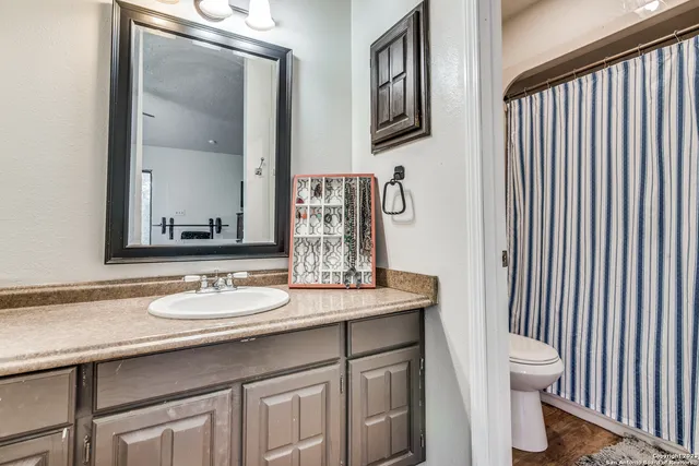 a bathroom with a granite countertop sink and a mirror