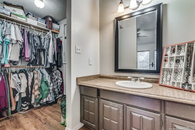 a view of a bathroom with a sink and mirror