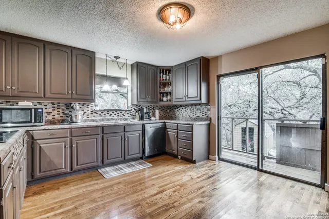 a kitchen with a stove a sink and a microwave