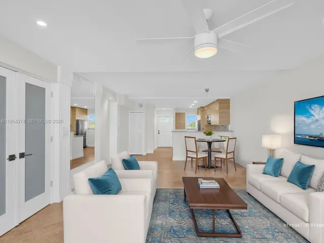 a view of a big room with wooden floor and windows