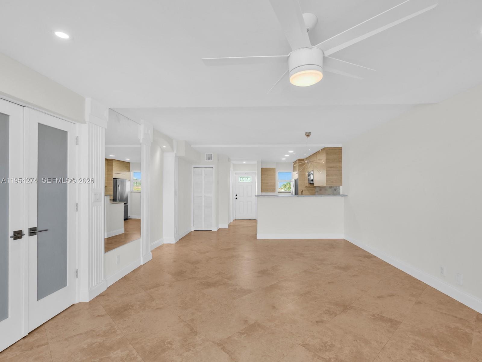 750 Northeast Spanish River Boulevard, Unit 5050 Boca Raton, FL 33431 - Photo 14 of 41 a view of a big room with wooden floor and windows