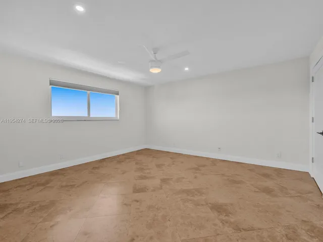 an empty room with a empty space and windows