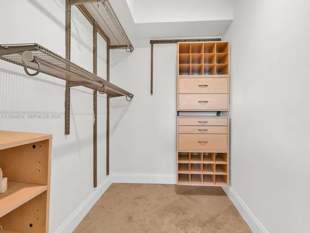 a view of a big room with a cabinet and mirrors