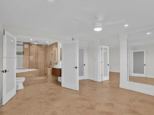 a bathroom with a granite countertop sink a toilet and shower