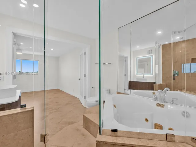 a bathroom with a shower and a sink