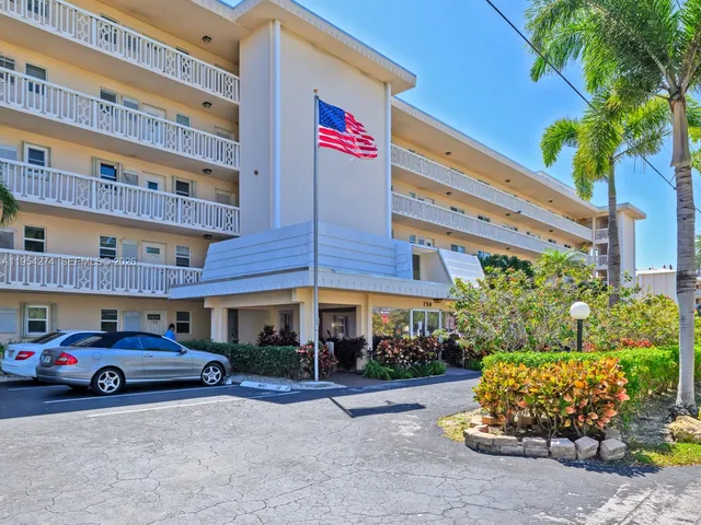a front view of building with multi story residential apartment building in front of it