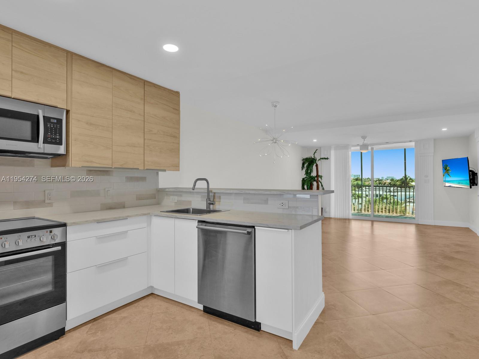 750 Northeast Spanish River Boulevard, Unit 5050 Boca Raton, FL 33431 - Photo 6 of 41 a kitchen with stainless steel appliances granite countertop a sink and cabinets