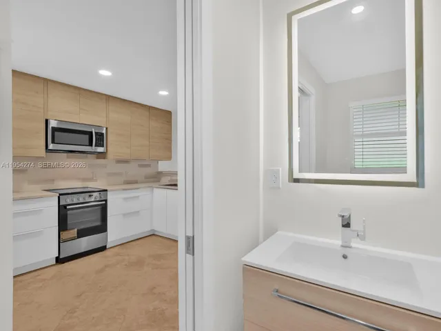 a bathroom with a sink a vanity and a mirror