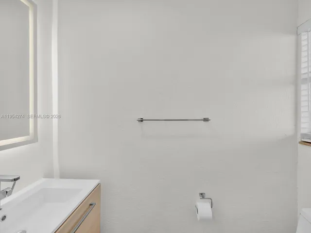 a bathroom with a sink and vanity