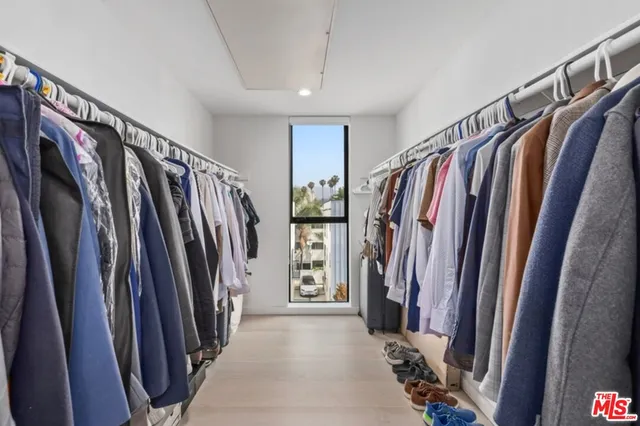 a spacious bathroom with a tub sink and mirror