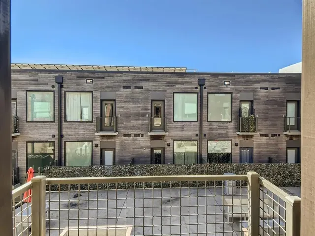 front view of a brick house with a large window