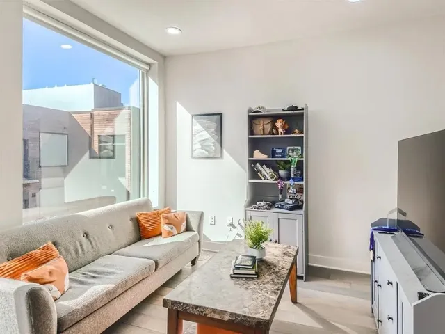 a living room with furniture a rug and a window