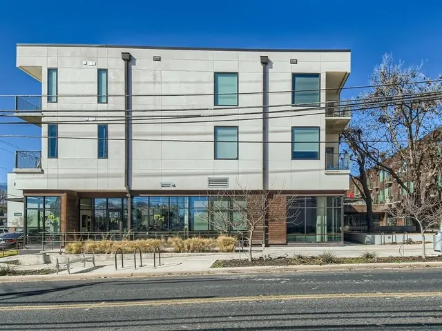 a tall building sitting on the side of a street