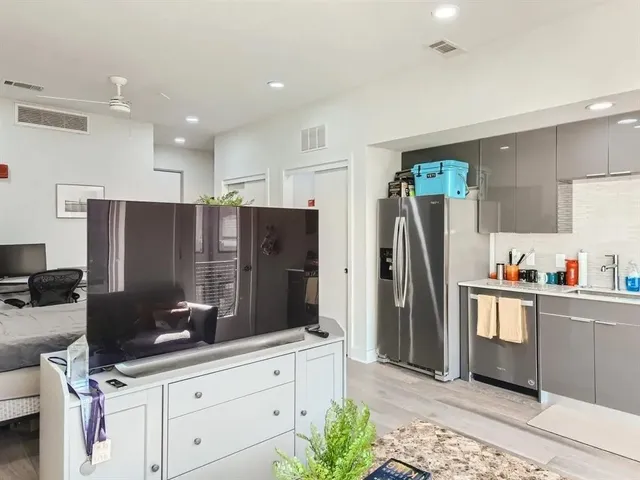 a kitchen with stainless steel appliances a refrigerator sink and microwave