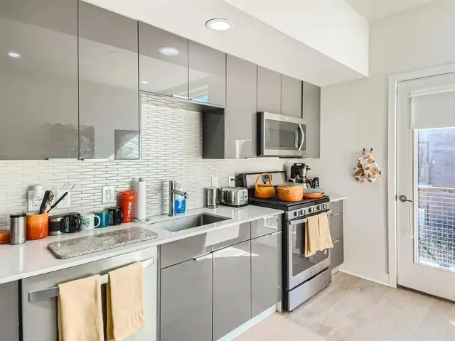 a kitchen with stainless steel appliances granite countertop a stove sink and cabinets