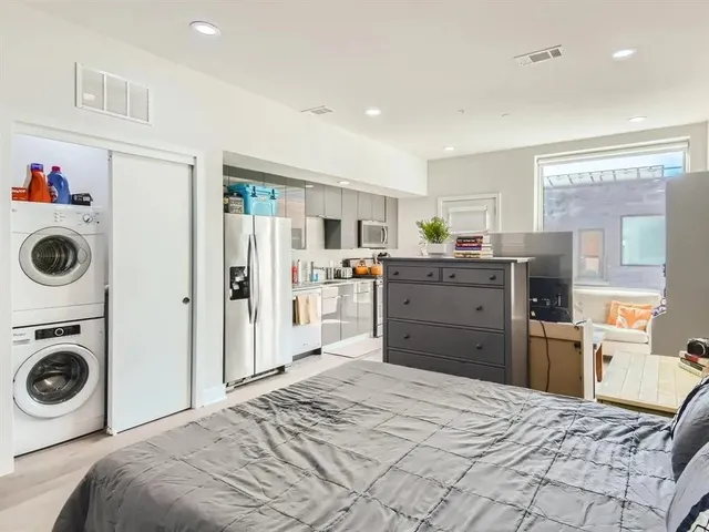 a bedroom with a bed and cabinets