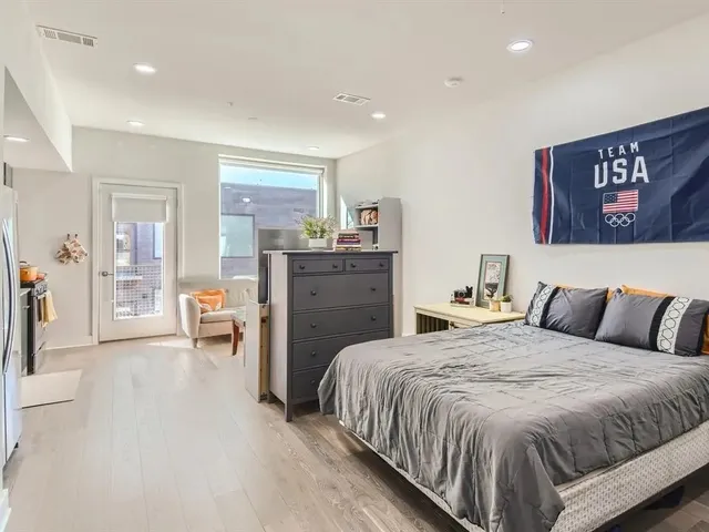 a spacious bedroom with a bed and furniture