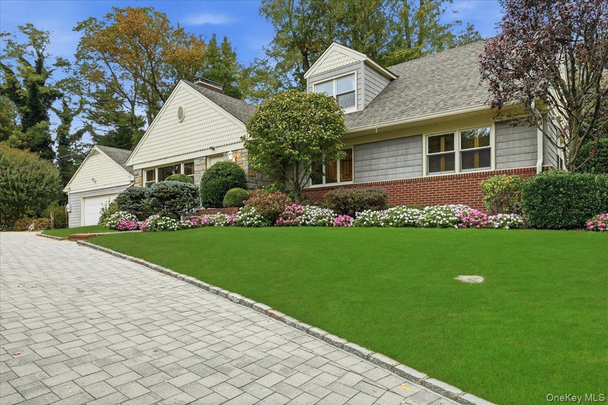 a front view of a house with a garden