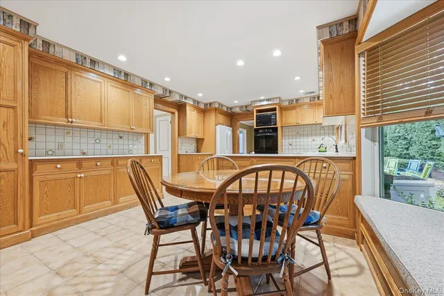 a view of a chairs and table in the kitchen