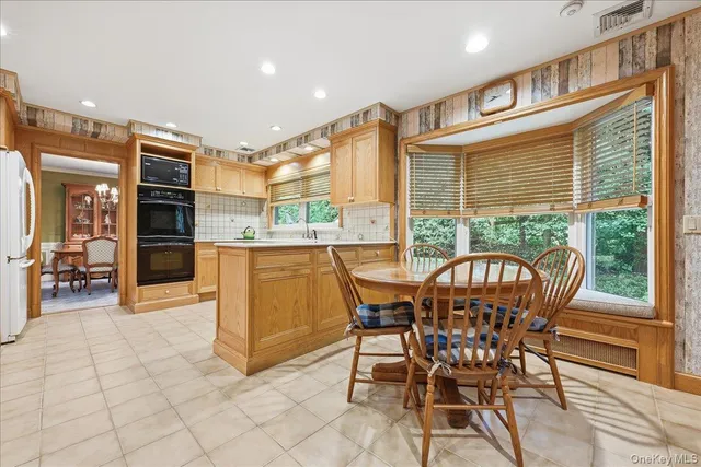 a view of a dining room with furniture window and outside view