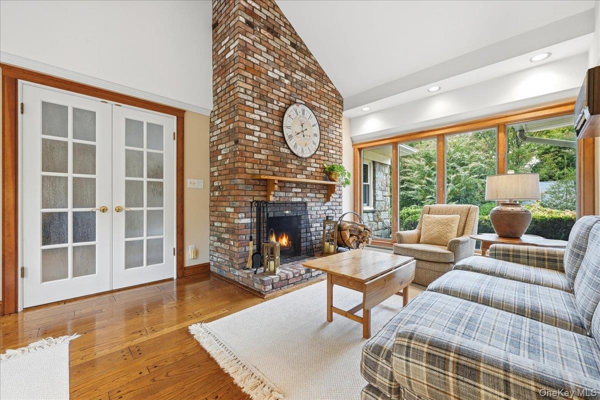 88 Luquer Road Manhasset, NY 11030 - Photo 15 of 38 a living room with furniture a fireplace and a floor to ceiling window