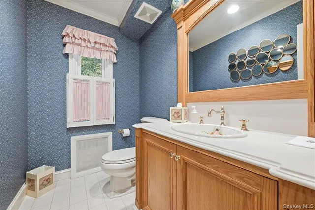 a bathroom with a sink a toilet and a window