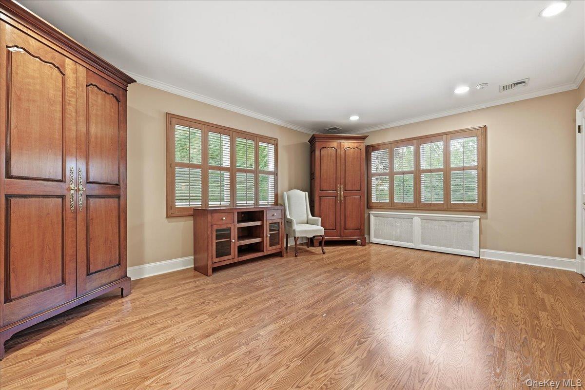 88 Luquer Road Manhasset, NY 11030 - Photo 19 of 38 an empty room with wooden floor and furniture