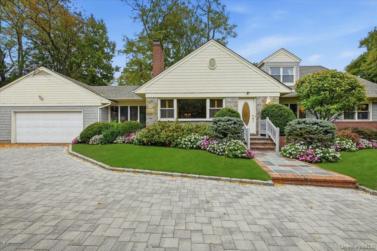 88 Luquer Road Manhasset, NY 11030 - Photo 2 of 38 a front view of a house with a garden