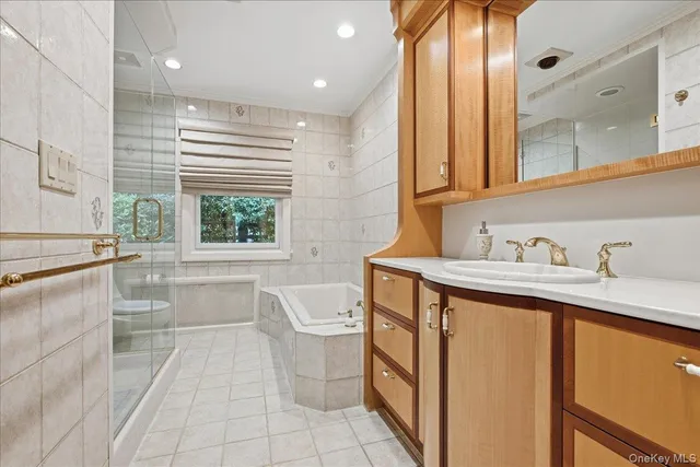 a bathroom with a granite countertop sink a toilet and mirror