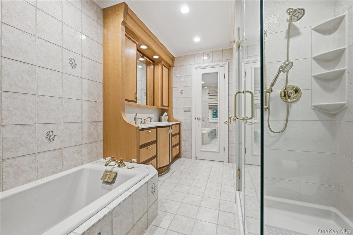 88 Luquer Road Manhasset, NY 11030 - Photo 22 of 38 a bathroom with a tub a sink and a shower