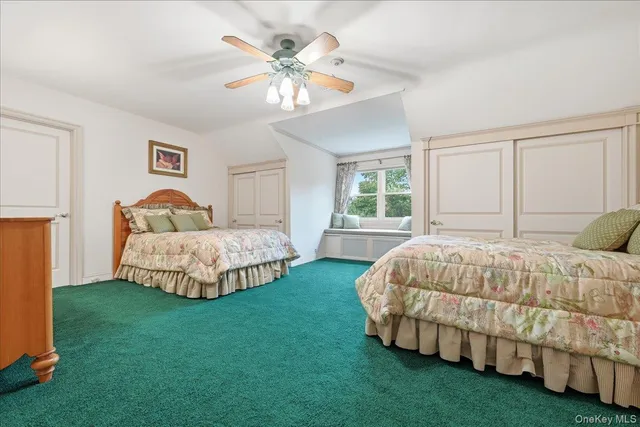 a bedroom with a bed chandelier and window