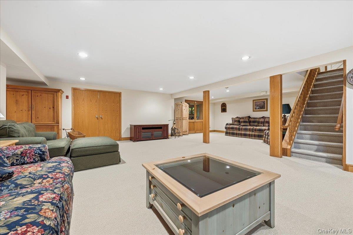 88 Luquer Road Manhasset, NY 11030 - Photo 29 of 38 a living room with furniture and a flat screen tv