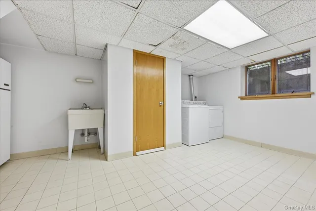 a view of a kitchen with furniture and a refrigerator