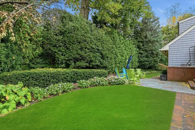 a view of a house with a yard and sitting area