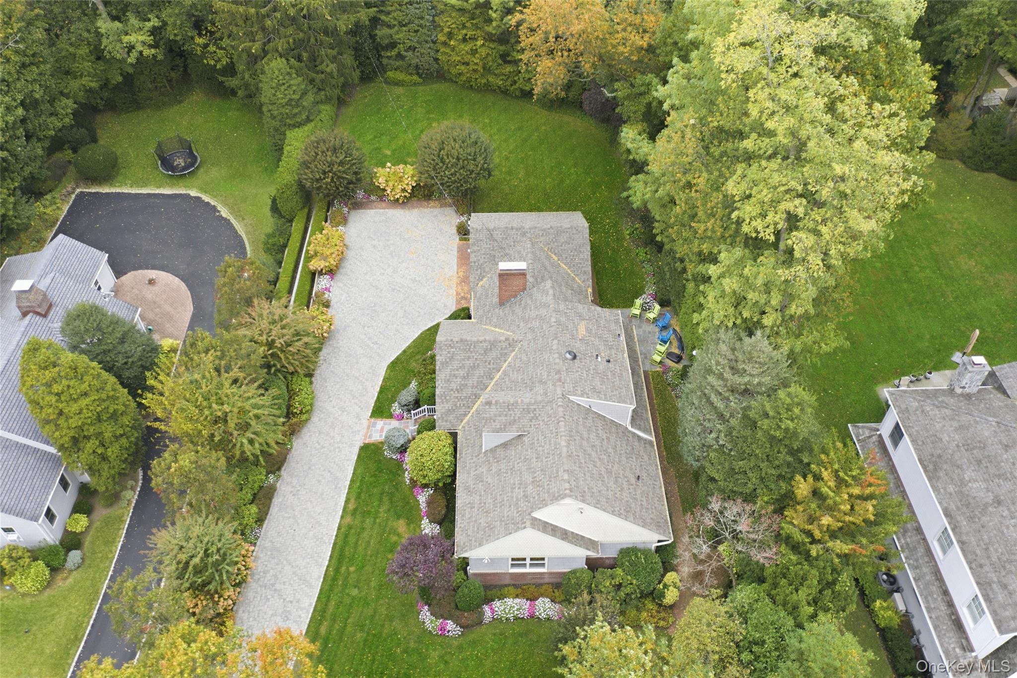88 Luquer Road Manhasset, NY 11030 - Photo 37 of 38 an aerial view of a house with outdoor space and a lake view in back