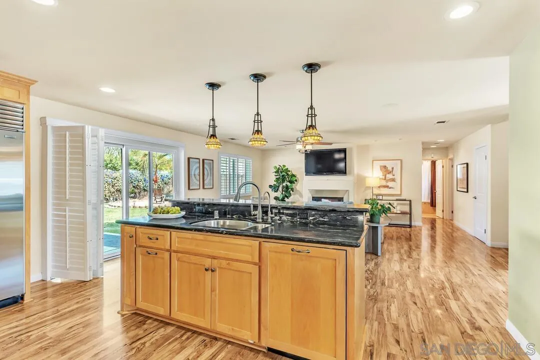 14228 Frame Road Poway, CA 92064 - Photo 11 of 49 a kitchen with counter top space and wooden floor
