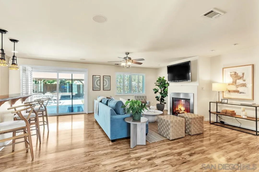 14228 Frame Road Poway, CA 92064 - Photo 12 of 49 a living room with furniture a fireplace and a flat screen tv