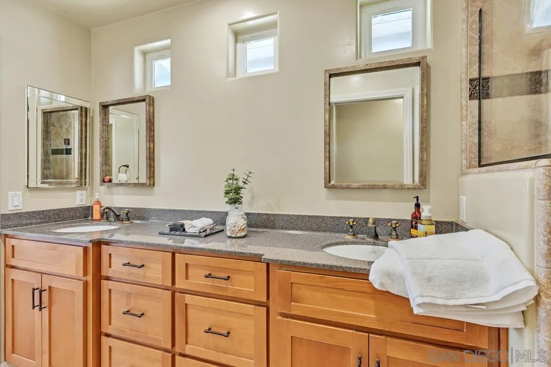 14228 Frame Road Poway, CA 92064 - Photo 25 of 49 a bathroom with cabinets two sinks and a wooden floor