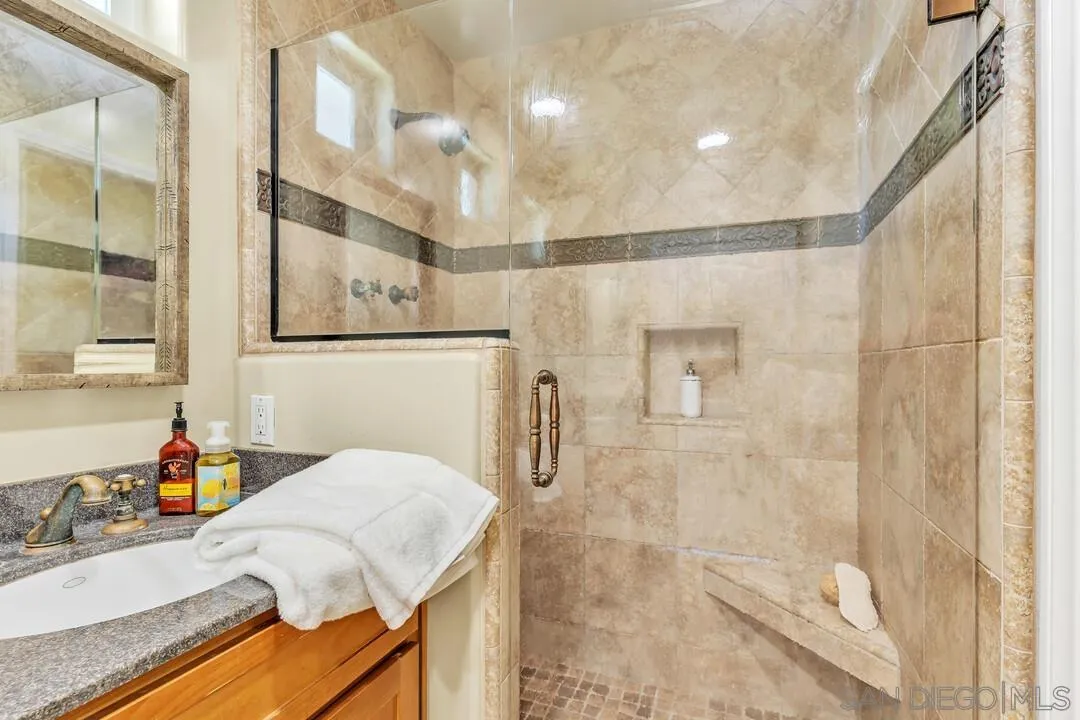 14228 Frame Road Poway, CA 92064 - Photo 26 of 49 a bathroom with a granite countertop sink a shower and a mirror