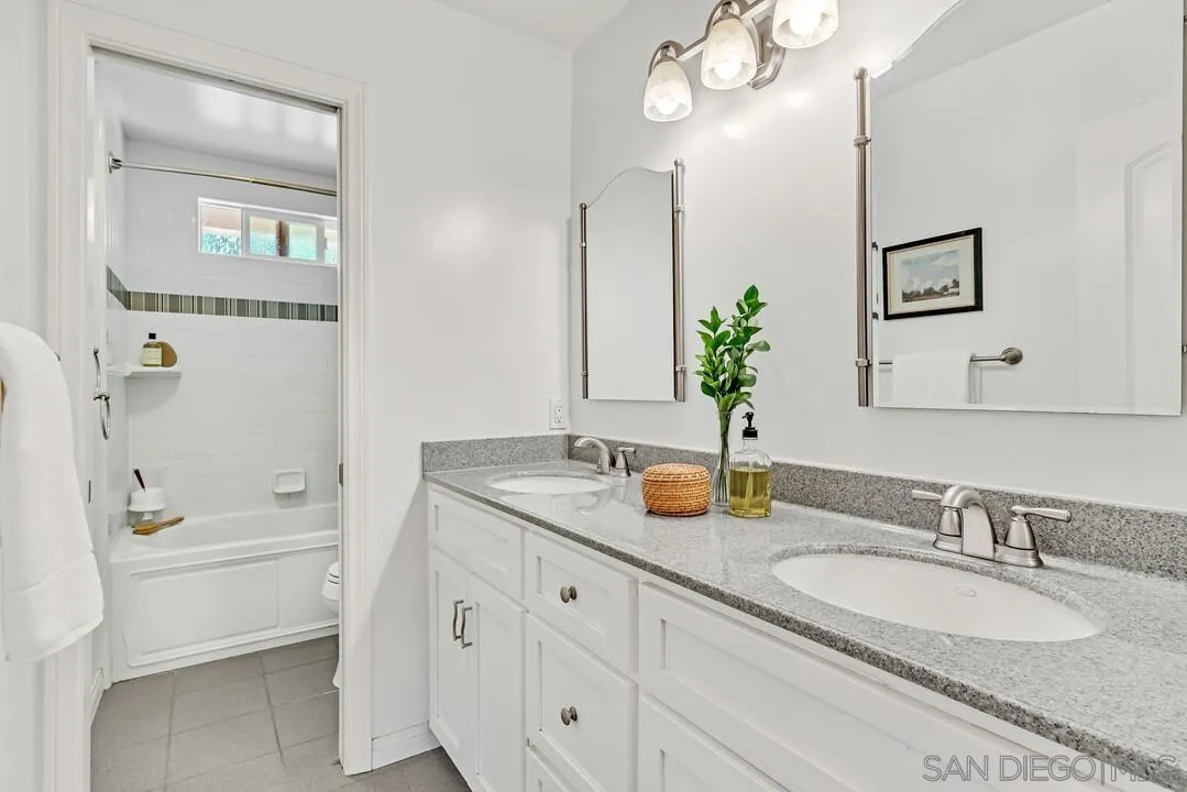 14228 Frame Road Poway, CA 92064 - Photo 29 of 49 a bathroom with a granite countertop sink and a mirror