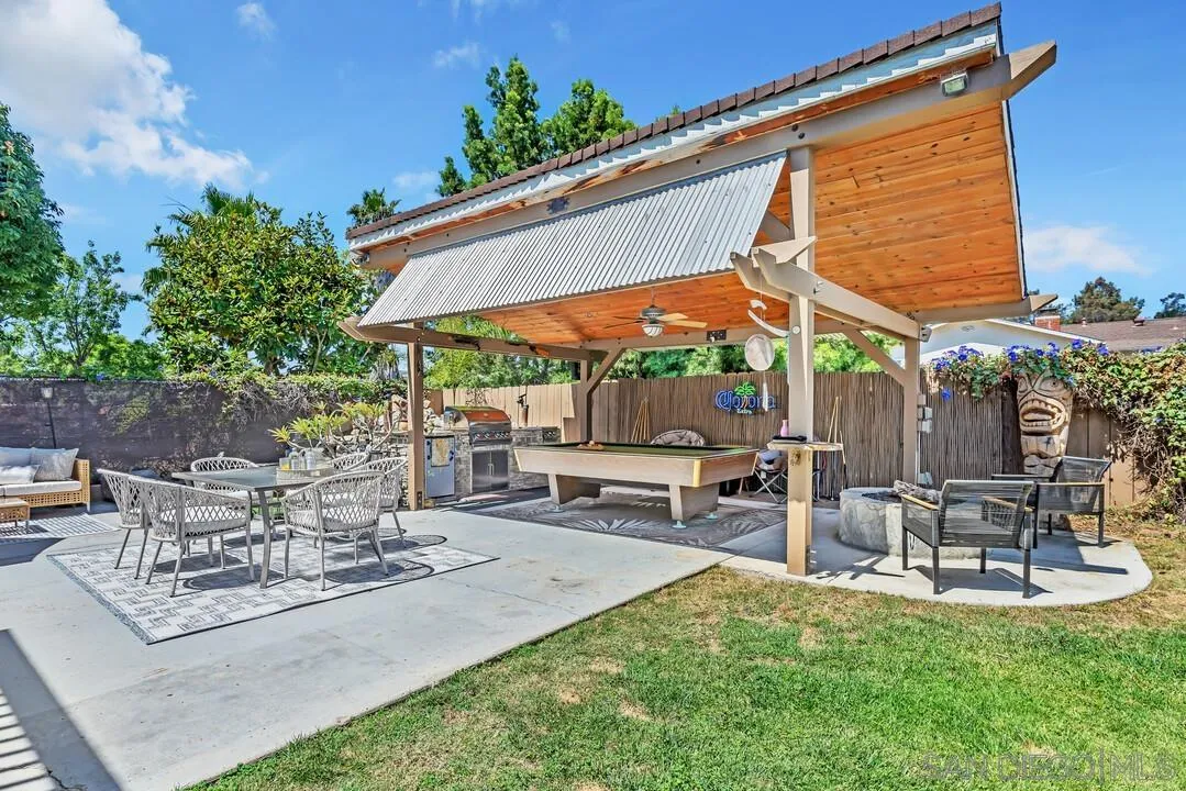 14228 Frame Road Poway, CA 92064 - Photo 35 of 49 a view of a patio with table and chairs under an umbrella